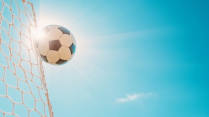 Ball sinking through the net, bright clear sky above.