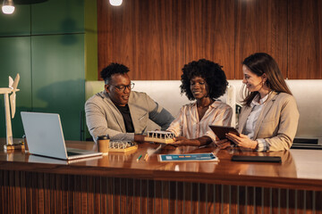 Diverse team of ecologists with solar panels working on green solution