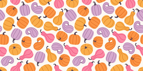 Seamless autumn pattern with pastel pumpkins and gourds in orange, purple, pink, and yellow colors. Thanksgiving Day. Harvest backdrop. Background for fall seasonal decorations, and cozy home decor.