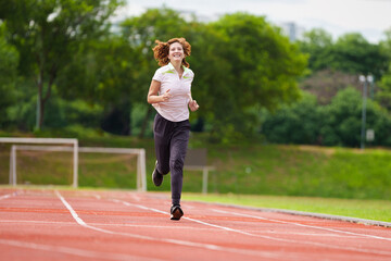 Active woman exercising. Fit slim girl running