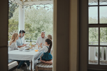 Food, brunch and table with family on house porch with wine for celebration or festive holiday. Cooking, feast or lunch with people eating in home together for party event or social gathering