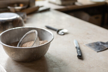 Tools and ingredients for baking bread displayed on a rustic tabletop in a cozy kitchen setting 
