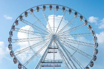 A ferris wheel stands tall against blue sky