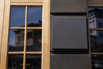 A blank chalkboard on a restaurant exterior in the afternoon sunlight