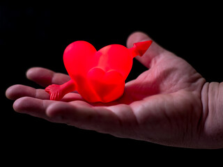 Obraz premium Hand holds a heart-shaped object