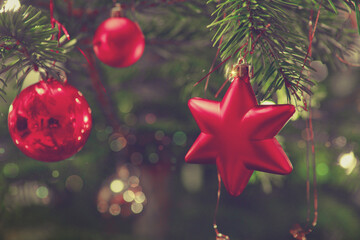 Christmas and New Years background with fir tree and red decoration.