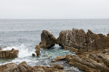 Waves breaking on the Kissing Rocks in the ocean