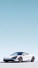 Fototapeta premium A stylish black sports car is positioned against a smooth blue background, highlighting its aerodynamic design and sleek contours