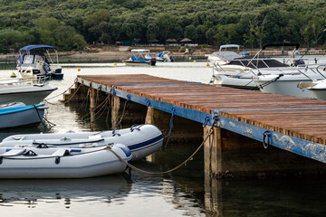Wooden jetty with moorings for yachts and small boats in a bay on the Mediterranean coast in Croatia