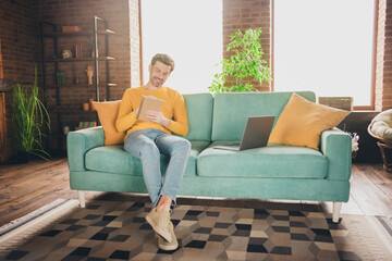Obraz premium Full body photo of nice young man sit couch online study write notebook wear yellow clothes modern interior flat indoors