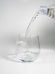 Pour Water Into Empty Glass Isolated On White Background