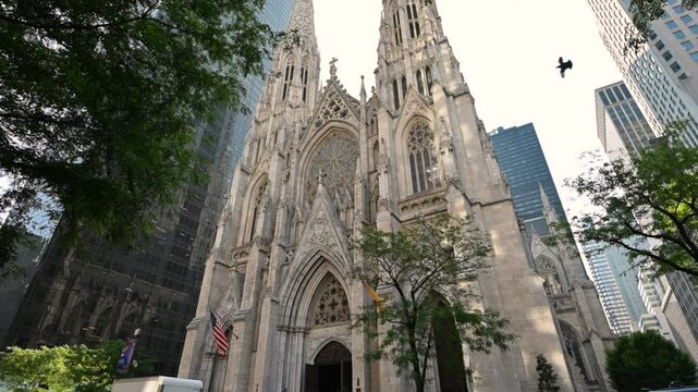 New York City, USA, August 14, 2024. The gothic St. Patrick's Cathedral in a tilt shot. It is striking in comparison with the modern skyscrapers that surround it. Beautiful summer day.
