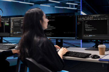 Programmer in data center using PC to check for server performance issues caused by low disk space....