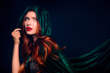 Photo of stunning girl look evil witch empty space wear green hood cape cloak isolated dark blue...