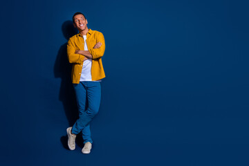 Photo of guy wearing yellow shirt folded hands confident looking interested shopping offer isolated on dark blue color background