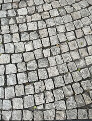 Light gray paving stones that have become smooth due to many passers-by