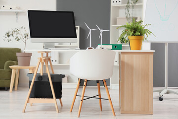 Fototapeta premium Sustainable energy and green office workspace, eco-friendly business environment with wind turbine models
