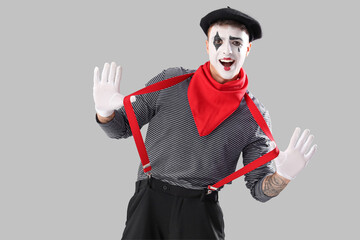 Male pantomimist  on grey background