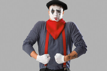 Male pantomimist  on grey background
