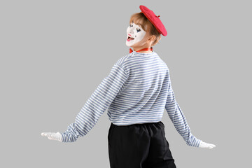 Female pantomimist  on grey background