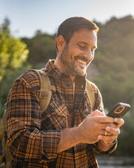 Adult man explore nature while check mobile phone in a serene setting