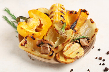 Plate with tasty grilled vegetables on white background