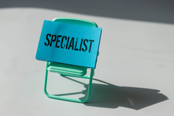 Office stationary and ID card with text SPECIALIST,