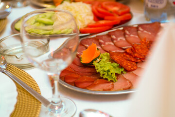 ham, roast beef and sausage served with vegetables and salad, as well as peppers with sour cream