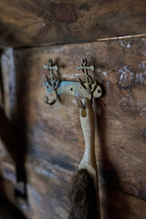 Vintage brush hanging on anchor-shaped hooks