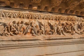 Romans, ancient and ruins in Turkey, art and architecture with travel, culture and blue sky. Empty, tourism and city with old town, environment and buildings with structure, decoration and stone