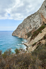 Breathtaking Coastal Vista Majestic Rocky Cliff Overlooking Azure Sea Waves Horizon Cloudless Sky Sunny Day Nature Tourism. Panoramic Seascape Rugged Cliffside Verdant Trees Turquoise Waters Rolling