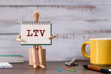 There is notebook with the word LTV. It is an abbreviation for Life Time Value as eye-catching...