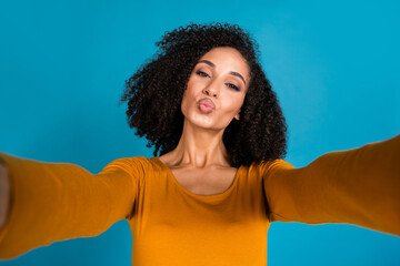 Photo portrait of nice young lady take selfie photo kissing lips dressed stylish yellow garment isolated on blue color background