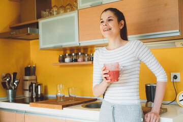 Happy caucasian woman drinking her smoothie, living a healthy lifestyle