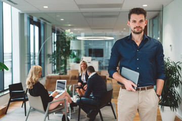 Portrait of a young businessman standing in modern office