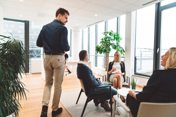 Colleagues having a debate in office lounge