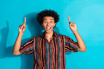 Photo of young guy wavy hair wearing summer trendy shirt index fingers up shock cheap products...