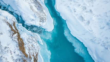 Turquoise river flowing between snow covered banks in winter