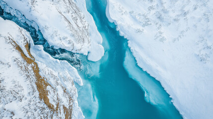 Turquoise river flowing through snowy landscape in winter