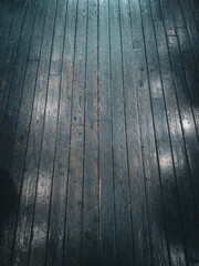 Background image of a floor made of old, wooden boards with traces of life.