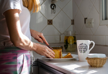 Woman cutting a homemade cake in the kitchen.