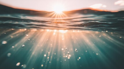 Sunlight filters through the water, illuminating the ocean depths and creating beautiful, shimmering patterns as the sun sets