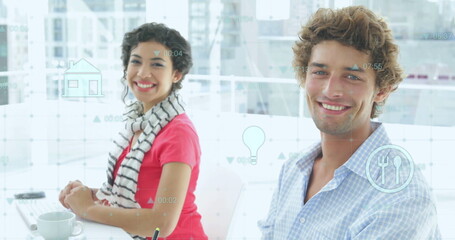 Image of icons and data processing over caucasian male and female colleague at casual office