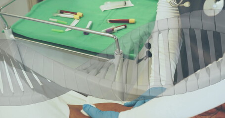 Image of dna strand over blood samples on table and doctor in hospital