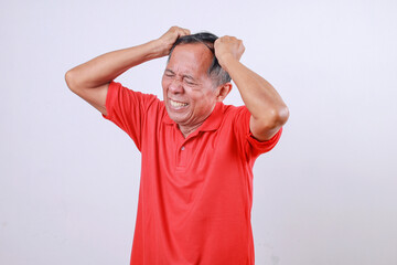 Asian senior man put hands on head suffering from headache and stressed because pain and migraine