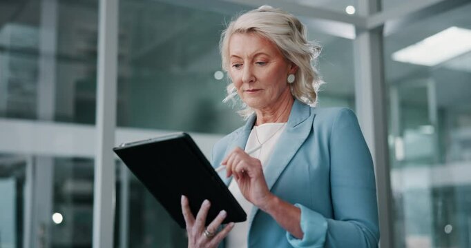 Mature, business woman or research with tablet at office for communication, network or connectivity. Female person, analyst or employee reading or working on technology for online report at workplace