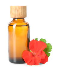 Bottle of geranium essential oil and beautiful flower isolated on white