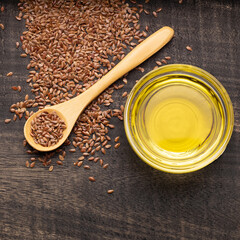 Organic flax seeds and oil in the glass bowl - Linum usitatissimum.