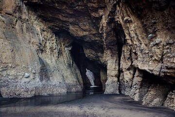 Rocky interior of a cave on the beach at Piha, Auckland, New Zealand.