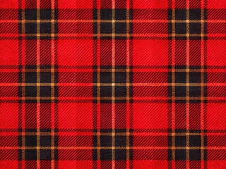 Vibrant red and black plaid fabric textured background with subtle sheen, showcasing a classic tartan pattern with intersecting crisscross lines and bold square motifs.